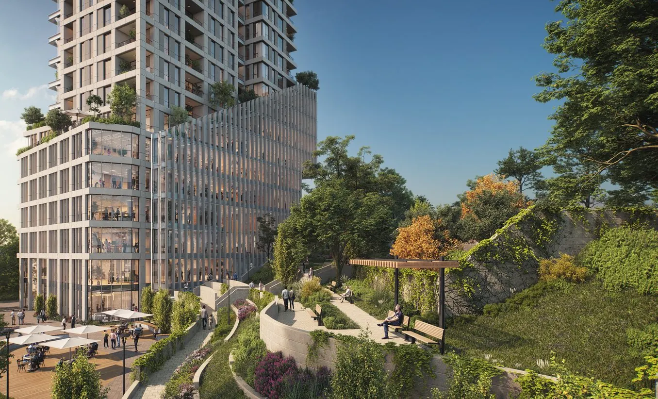 The tower beside landscaped park terraces and walking paths